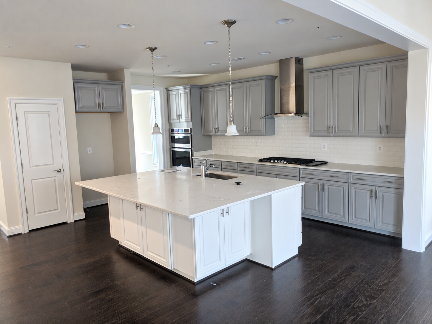 Gray custom kitchen with large island and full-height cabinetry